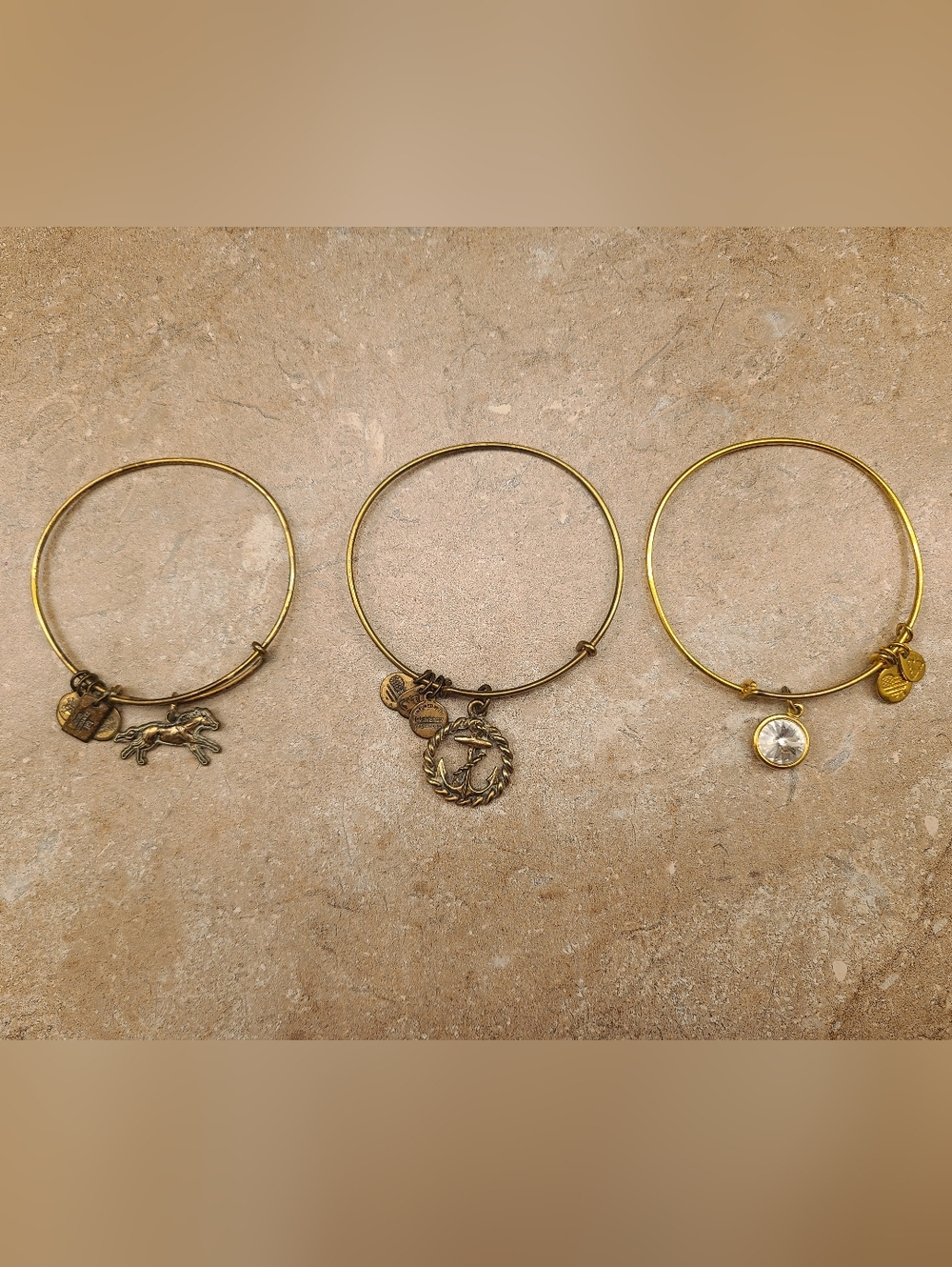 Set of 3 gold tone Alex and Ani charm bangles